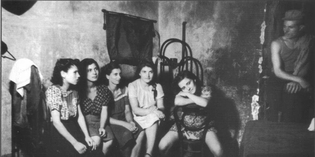 Interior of a brothel in Naples Italy 1945 - Five prostitutes waiting for customers